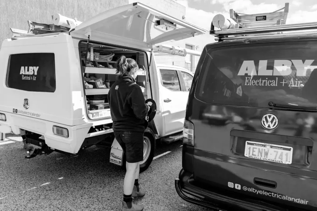 Technician inspecting electrical service vehicles, highlighting tips for maintaining your electrical system.