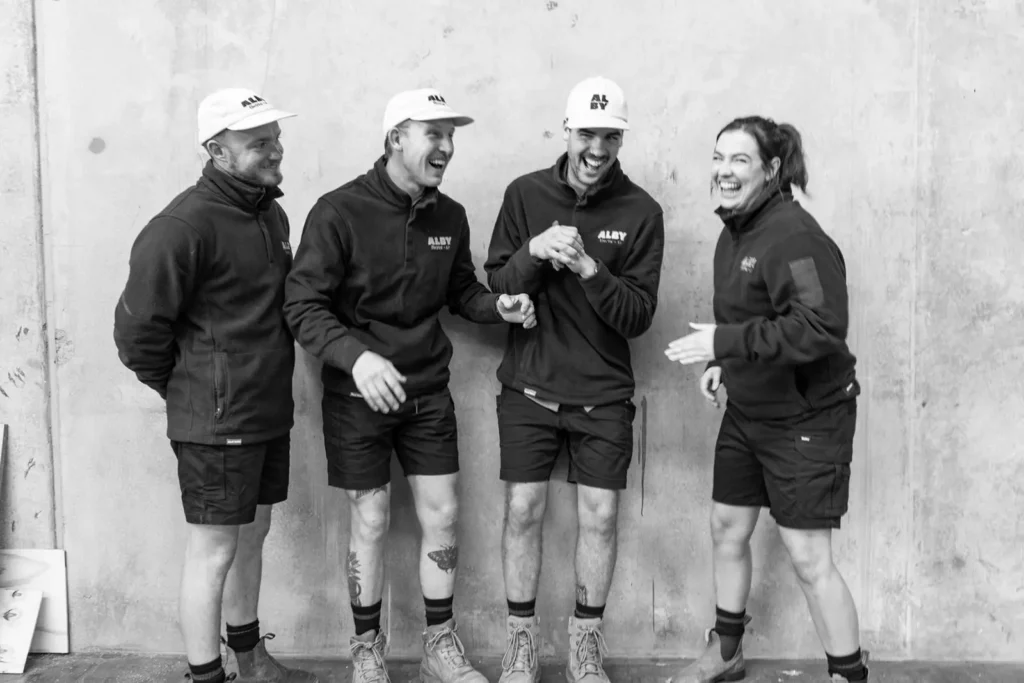 Alby Electrical & Air team laughing together while discussing electrical services in Perth.