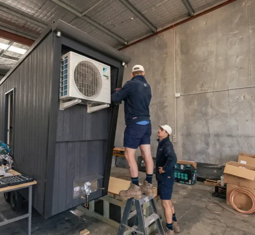 Technicians installing an air conditioning system for optimal performance in Perth’s hot summers.