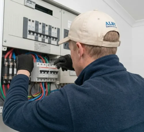 Technician from Alby Electrical & Air upgrading a Perth home's switchboard for safety.